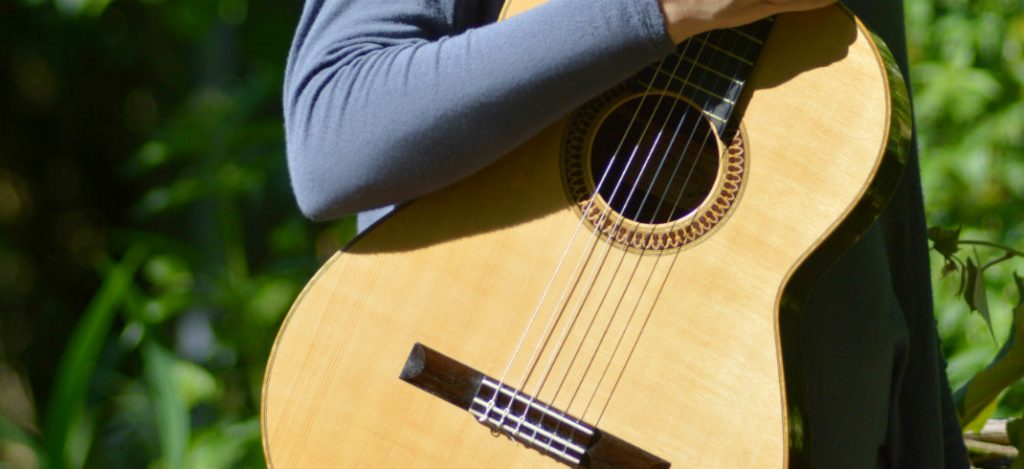 person holding a classical guitar